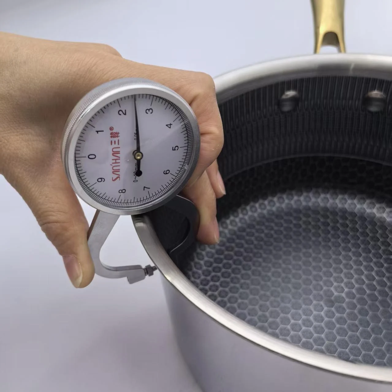 digital caliper measuring 2 5mm thickness triply stainless steel cookware