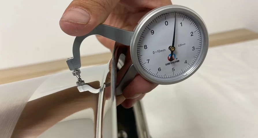 Cookware factory checking stainless steel pot wall thickness with a dial thickness gauge