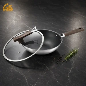 GS-01702-FP tri-ply titanium frying pan with glass lid, brown handle, and polished stainless steel exterior
