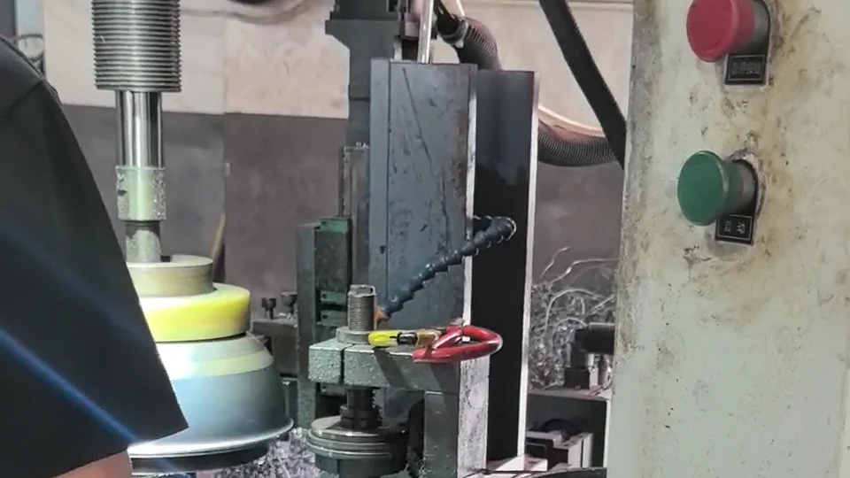 Rotating stainless steel cookware body during edge trimming