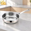 GS-01802-FP 5-ply copper core stainless steel frying pan with copper-colored band and riveted long handle on a kitchen counter